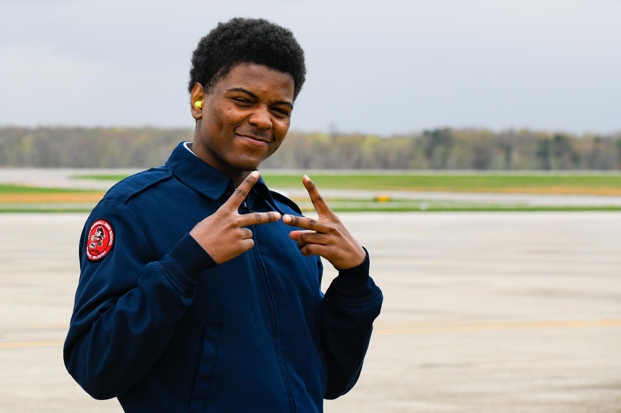 A John Marshall High School Air Force Junior Reserve Officers' Training Corps cadet smiles for a photo after his flight on a C-130H Hercules aircraft assigned to the 910th Airlift Wing, April 17, 2023, at Youngstown Air Reserve Station.