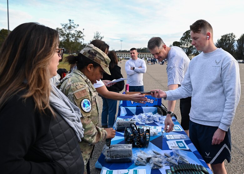 Members of Hawk's COVE shows up in full force at the Delta Dash to speak about Sexual Assault Awareness and Prevention Month at Vandenberg Space Force Base, Calif., April 7, 2023. U.S. Space Force Col. Robert Long, Space Launch Delta commander, checks out what was showcased at the SAAPM table for the runners at the Delta Dash. (U.S. Space Force photo by Senior Airman Tiarra Sibley)