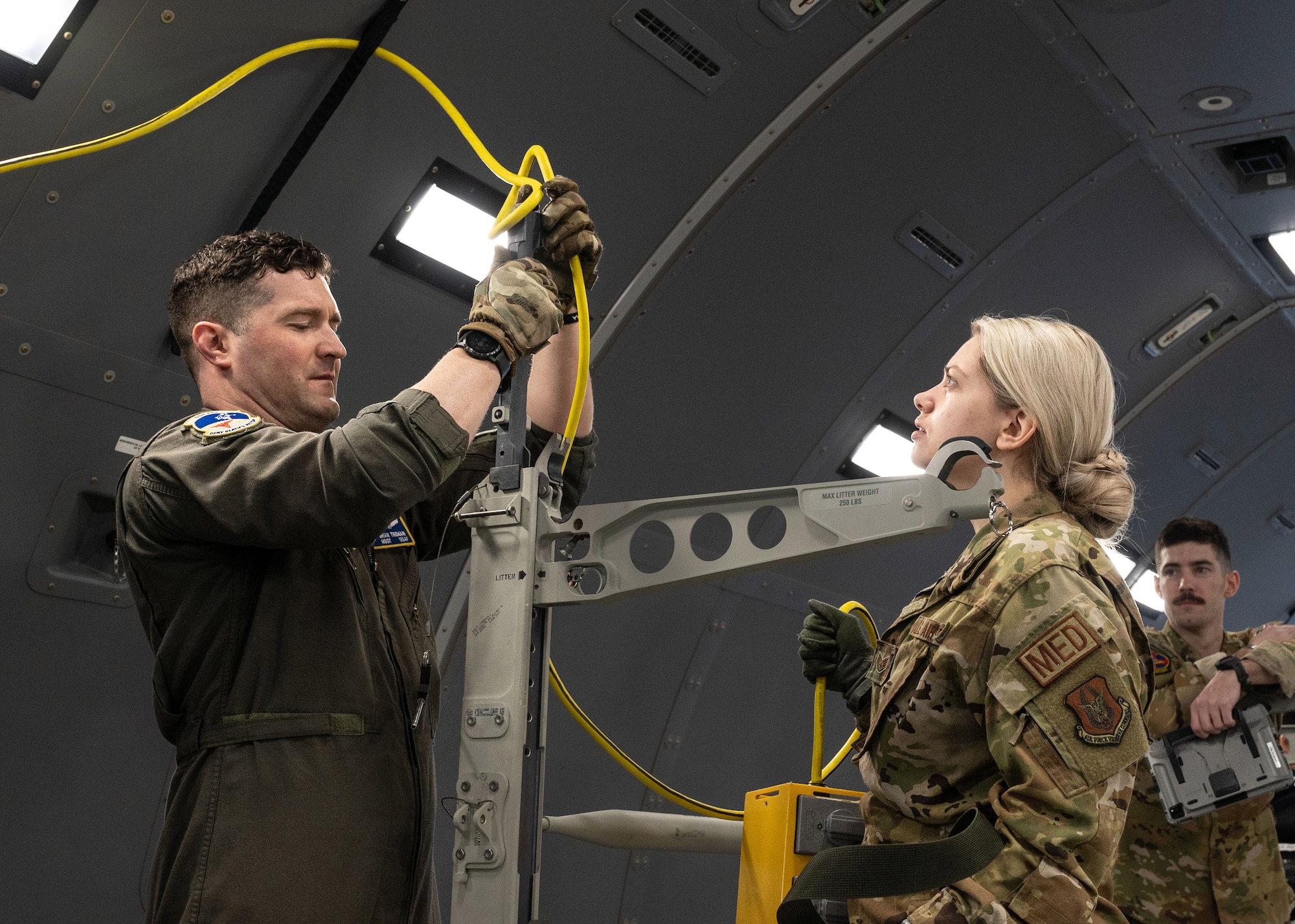 Master Sergeant Brian Tremain, a 934th Aeromedical Evacuation Squadron flight medical technician, left, and Staff Sgt. Samantha Fortman, 934 AES aeromedical evacuation technician, secure a line of oxygen inside a Boeing KC-46 Pegasus aircraft at the Minneapolis-St. Paul Air Reserve Station, Minnesota, March 23, 2023. Air crew members are responsible for setting up all medical equipment and structures within the plane before take-off. (U.S. Air Force photo by Senior Airman Victoriya Tarakanova)
