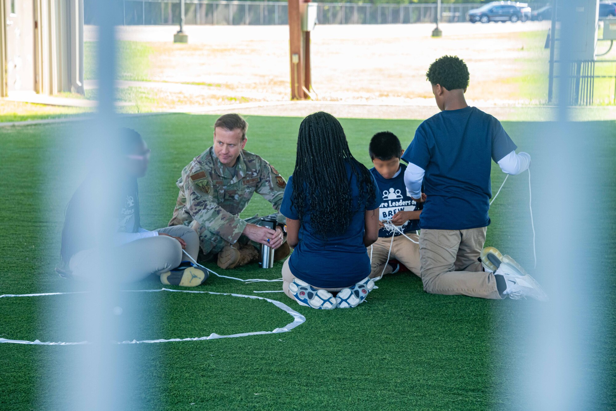 Air War College student Col. Jonathan Varoli spends time talking with 7th and 8th grade students at the Brewbaker Middle School Outreach Day at Maxwell Air Force Base, Alabama, April 18, 2023. The day was organized by the Montgomery Public Schools, the Air University Innovation Office and the Air University Innovation Research Task Force. Along with an opportunity to interact with military members, perhaps for the first time for some of the 13 students, the day included team- and leadership-building exercises, discussions about Air Force ‘heroes’ and on conflict resolution and respecting differing viewpoints. (U.S. Air Force photo by Sean Ross)