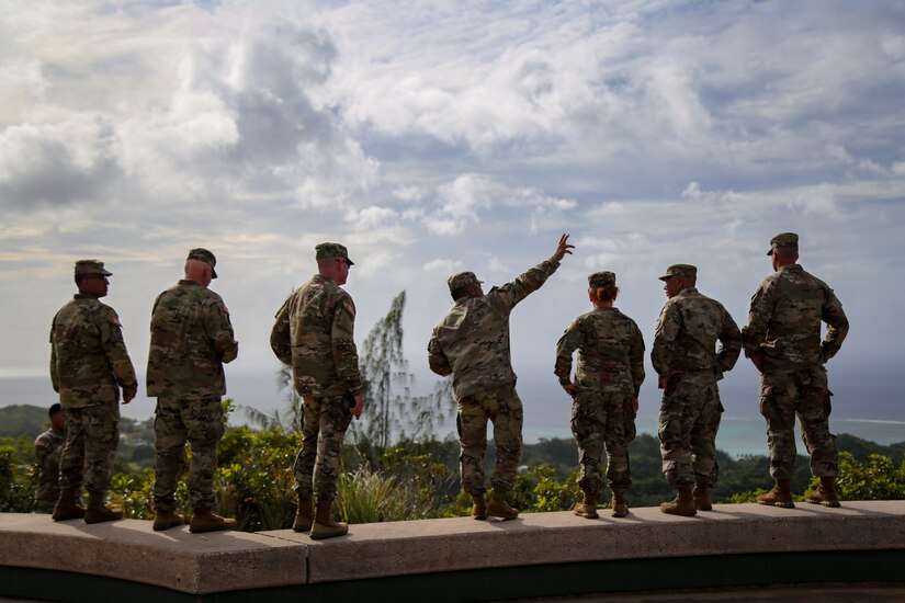 U.S. Army Col. David Santos, center, chief of joint staff of the Guam National Guard, gives a battlefield overview of the 1944 Liberation of Guam to the other chiefs of staff from the states of National Guard Region VII at the Asan Bay Overlook Memorial April 18, 2023.