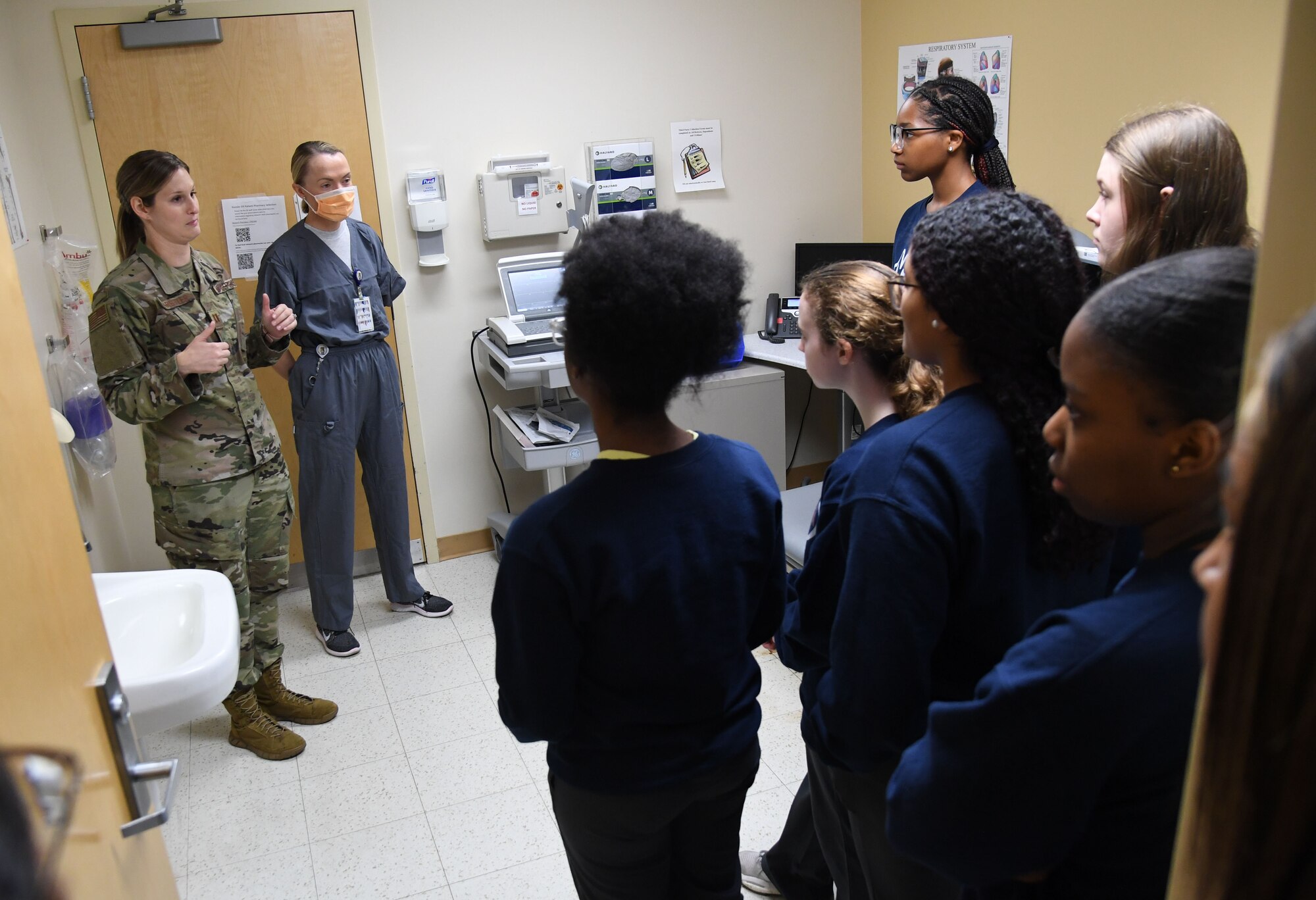 U.S. Air Force Capt. Kimberly Warstler, 81st Healthcare Operations Squadron element chief, and Capt. Anastasiya Zemtsova, 81st HCOS registered nurse, brief Pascagoula and Gautier High School students on the emergency room patient inprocessing procedures inside the Keesler Medical Center at Keesler Air Force Base, Mississippi, April 21, 2023.