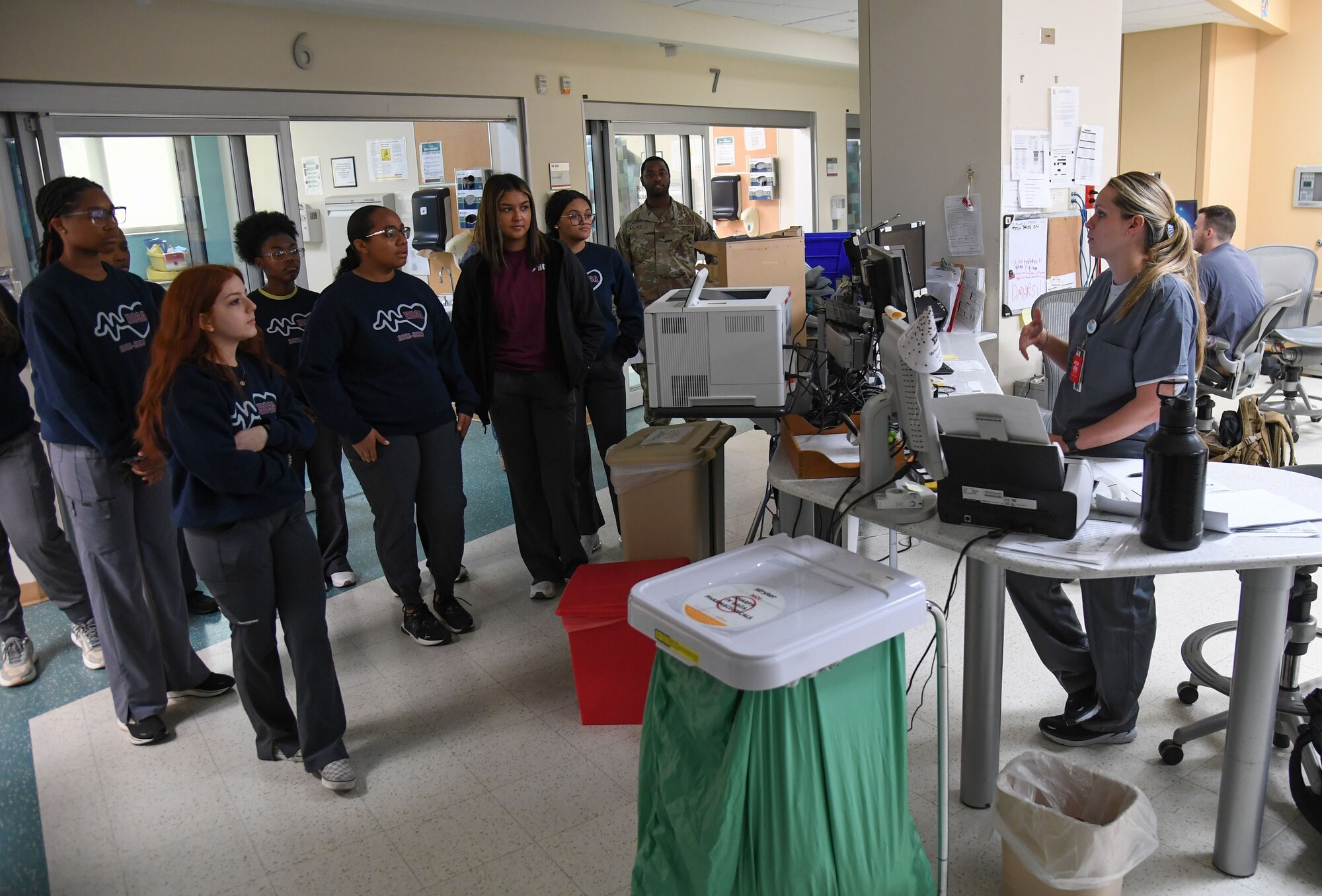 U.S. Air Force Capt. Katie Armstrong, 81st Healthcare Operations Squadron charge nurse, briefs Pascagoula and Gautier High School students on the emergency room patient procedures inside the Keesler Medical Center at Keesler Air Force Base, Mississippi, April 21, 2023.