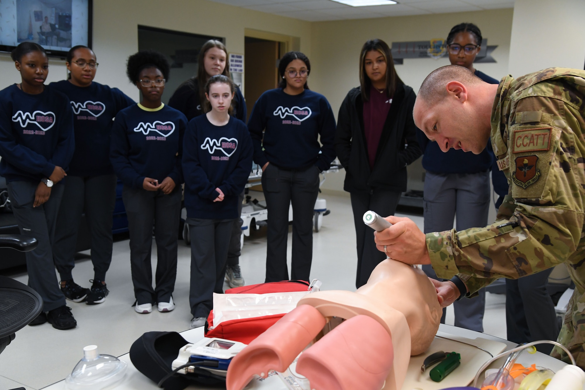 U.S. Air Force Capt. Max Hensel, 81st Healthcare Operations Squadron emergency room physician, demonstrates how to place an air way tube to Pascagoula and Gautier High School students inside the Keesler Medical Center at Keesler Air Force Base, Mississippi, April 21, 2023.