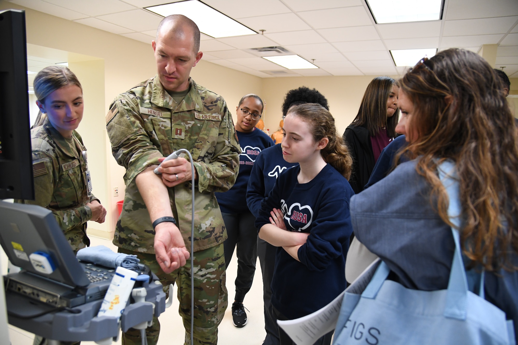 U.S. Air Force Capt. Max Hensel, 81st Healthcare Operations Squadron emergency room physician, demonstrates how to locate veins and arteries using an ultrasound to Pascagoula and Gautier High School students inside the Keesler Medical Center at Keesler Air Force Base, Mississippi, April 21, 2023.