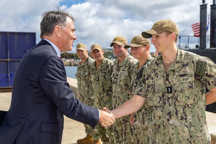 HMAS STIRLING, Australia (March 16, 2023) - Australian Deputy Prime Minister Richard Marles shakes hands with Lt. j.g. Michael Nix, assigned to the Los Angeles-class fast-attack submarine USS Asheville (SSN 758), before going onboard for a tour, March 16. Asheville conducted multiple tours for distinguished visitors during a routine port visit to HMAS Stirling, Western Australia to enhance interoperability and communication, and strengthen relationships with the Royal Australian Navy. (Courtesy photo by Australian Department of Defence)