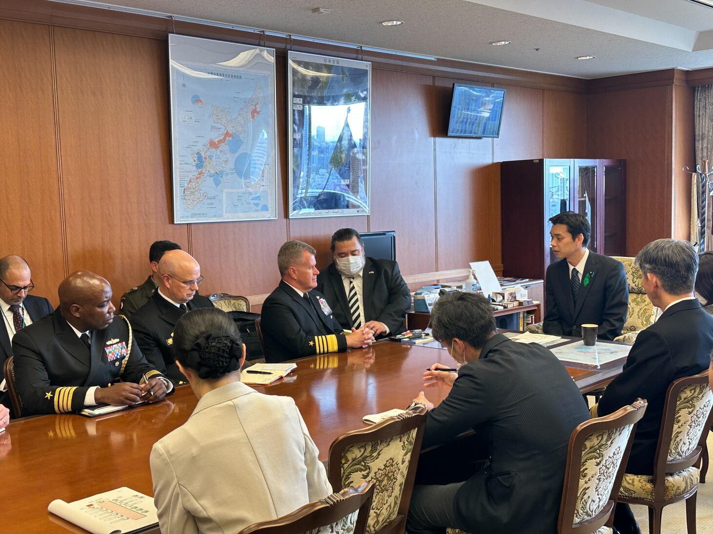 U.S. Navy Adm. Samuel Paparo speaks with Toshiro Ino and senior Japanese officials seated around a table.