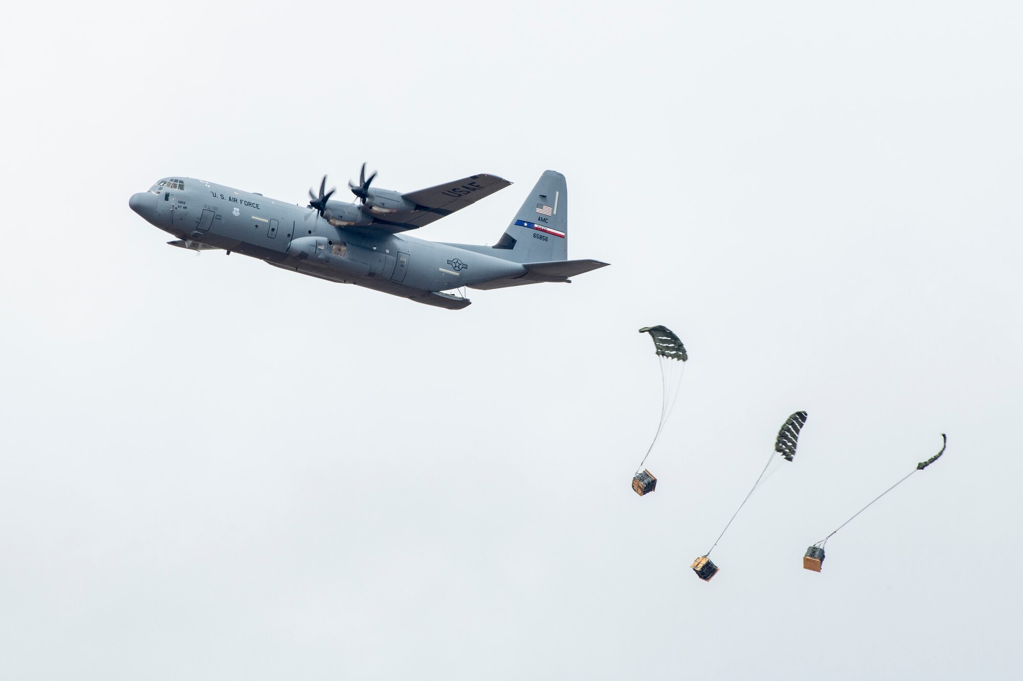 A C-130J Super Hercules team performs an airfield cargo drop demonstration during the 2023 Dyess Big Country Air Fest on Dyess Air Force Base, Texas, April 22, 2023. More than 30,000 event goers attended the one-day event highlighting the best of America’s only Lift and Strike base, Air Force heritage and Dyess community partners. The air show featured the F-22 Raptor demo team, U.S. Air Force Academy Wings of Blue, U.S. Army Golden Knights, WW II heritage flight and B-1B Lancer and C-130J Super Hercules fly overs. (U.S. Air Force photo by Senior Airman Mercedes Porter)