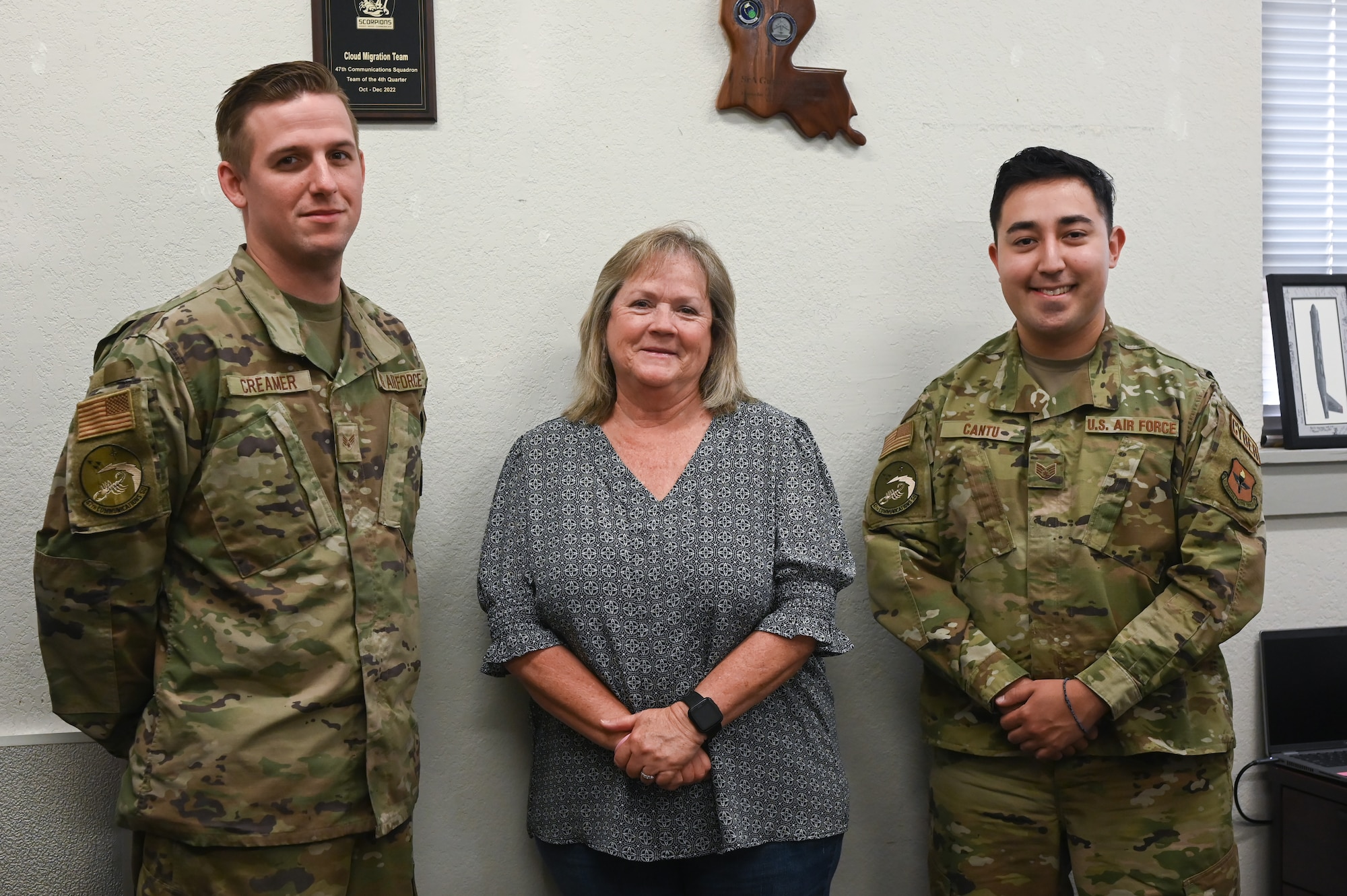 U.S. Air Force Senior Airman Zain Creamer (left), 47th Communications Squadron knowledge management technician, Alice Harlan (middle), 47th Communications Squadron base records manager, and Staff Sgt. Gustavo Cantu (right), 47th Communications Squadron knowledge management technician, pose for a Knowledge Management team photo at Laughlin Air Force Base, Texas, on April 17, 2023. The Air Force Records Management Program involves managing the creation, use, and disposition of records, including the preservation of important information and the disposal of records of temporary value. (U.S. Air Force photo by Airman 1st Class Keira Rossman)
