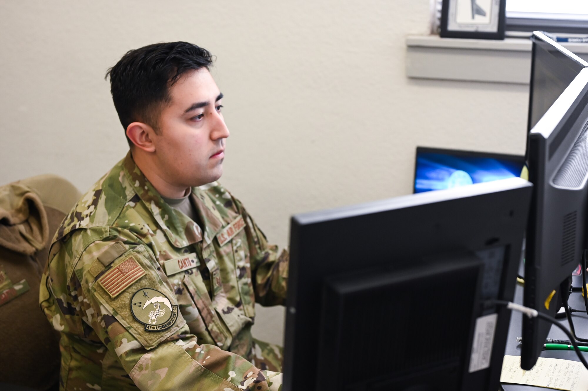 U.S. Air Force Staff Sgt. Gustavo Cantu, 47th Communications Squadron knowledge management technician, types on a computer at Laughlin Air Force Base, Texas, on April 17, 2023. The records management program provides evidence and accountability of Laughlin AFB to the public, Congress, and the Department of Defense. (U.S. Air Force photo by Airman 1st Class Keira Rossman)
