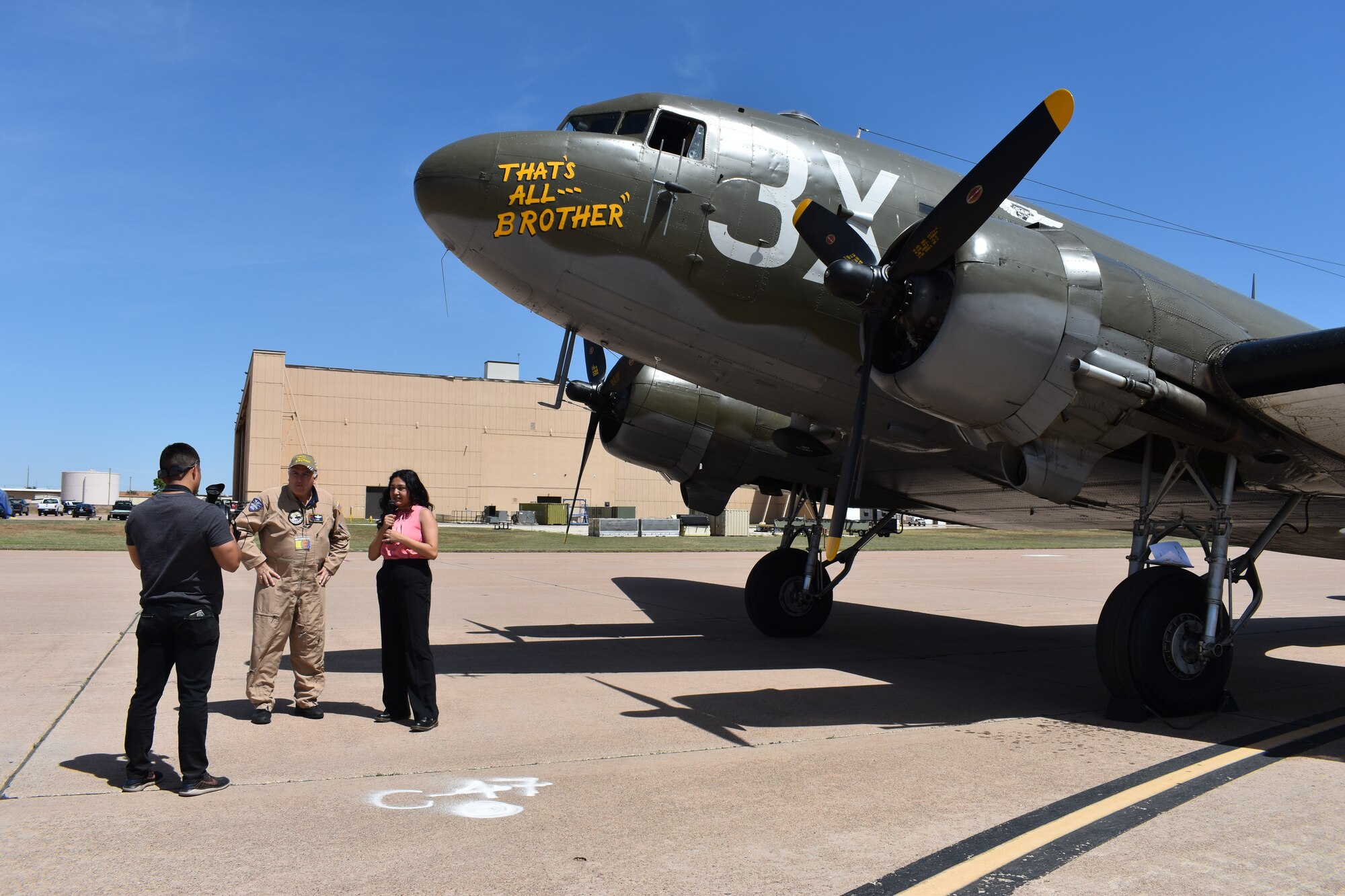 Abilene local media members interview T.J. Cook, Commemorative Air Force Ghost Squadron C-47 pilot, in front of the C-47 That’s All, Brother aircraft during the 2023 Dyess Big Country Air Fest rehearsal day at Dyess Air Force Base, Texas, April 21, 2023. More than 30,000 event goers attended the one-day event highlighting the best of America’s only Lift and Strike base, Air Force heritage and Dyess community partners. The air show featured the F-22 Raptor demo team, U.S. Air Force Academy Wings of Blue, U.S. Army Golden Knights, WWII heritage flight and B-1B Lancer and C-130J Super Hercules fly overs. (U.S. Air Force photo by Staff Sgt. Matthew Angulo)
