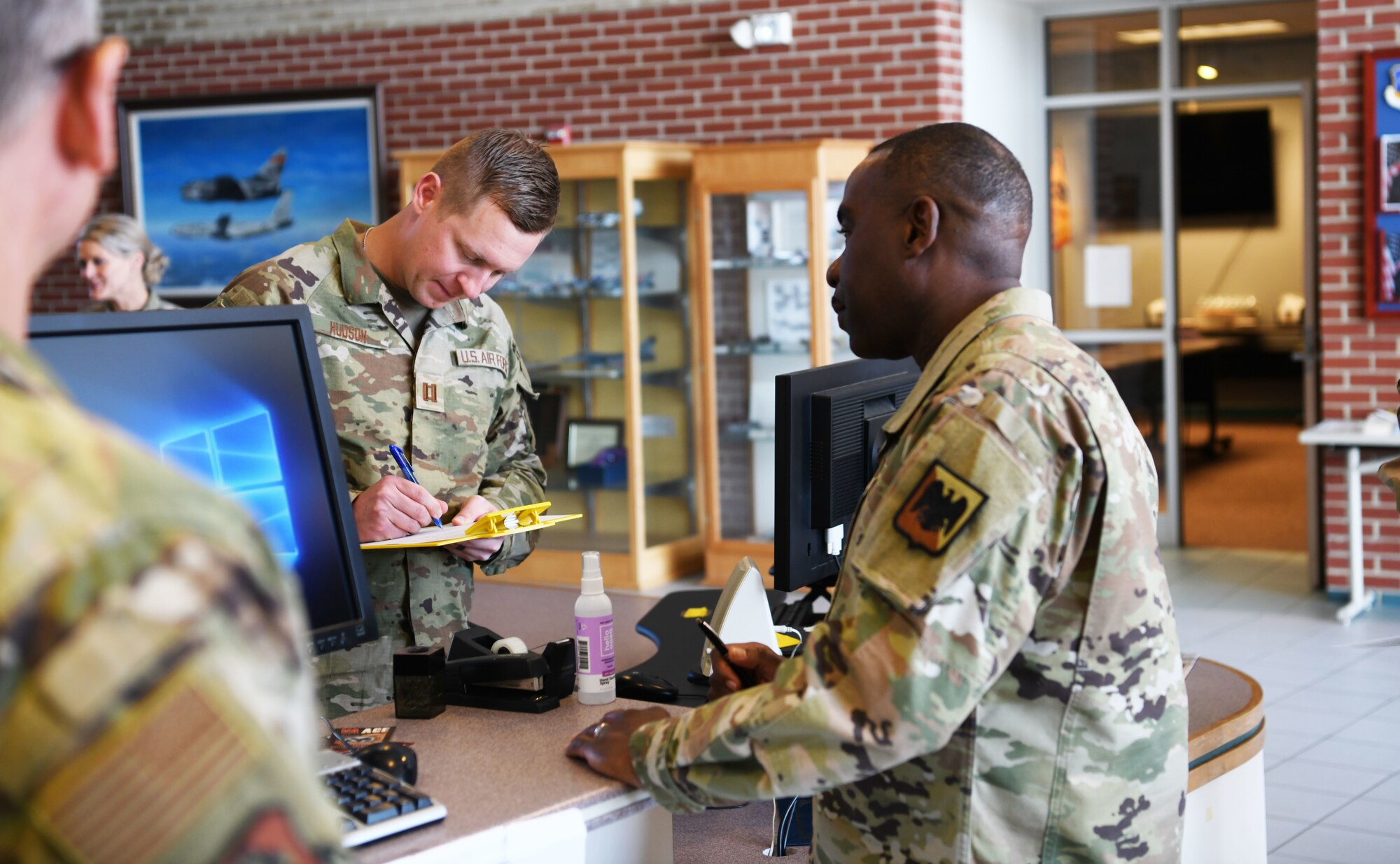 U.S. Air Force Chief Master Sgt. Maurice Williams, right, command chief, Air National Guard, files medical paperwork with Capt. Casey Hudson at the medical group information and check-in desk, Oct. 15, 2022, in Springfield, Ohio. Williams took the opportunity during his tour of the medical group to receive his annual influenza vaccination, a yearly requirement for all members of the U.S. military. (U.S. Air National Guard photo by Senior Airman Jillian Maynus).