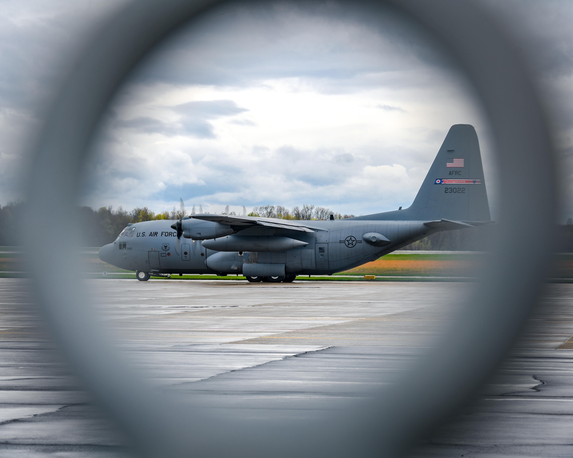 A C-130H Hercules aircraft assigned to the 910th Airlift Wing taxis for takeoff from Youngstown Air Reserve Station, Ohio, on April 17, 2023, with a cargo bay full of John Marshall High School Air Force Junior Reserve Officers' Training Corps cadets.