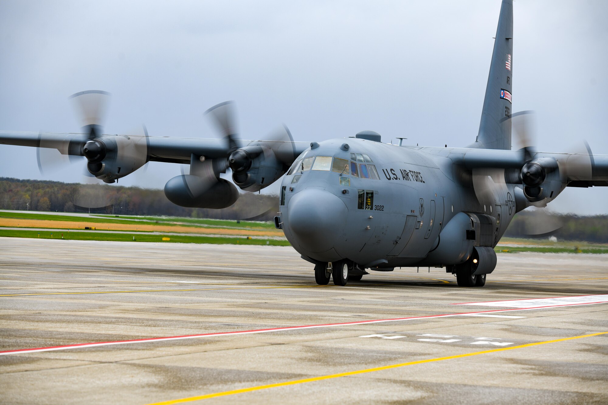 A C-130H Hercules aircraft assigned to the 910th Airlift Wing taxis for takeoff from Youngstown Air Reserve Station, Ohio, on April 17, 2023 with a cargo bay full of John Marshall High School Air Force Junior Reserve Officers' Training Corps cadets.