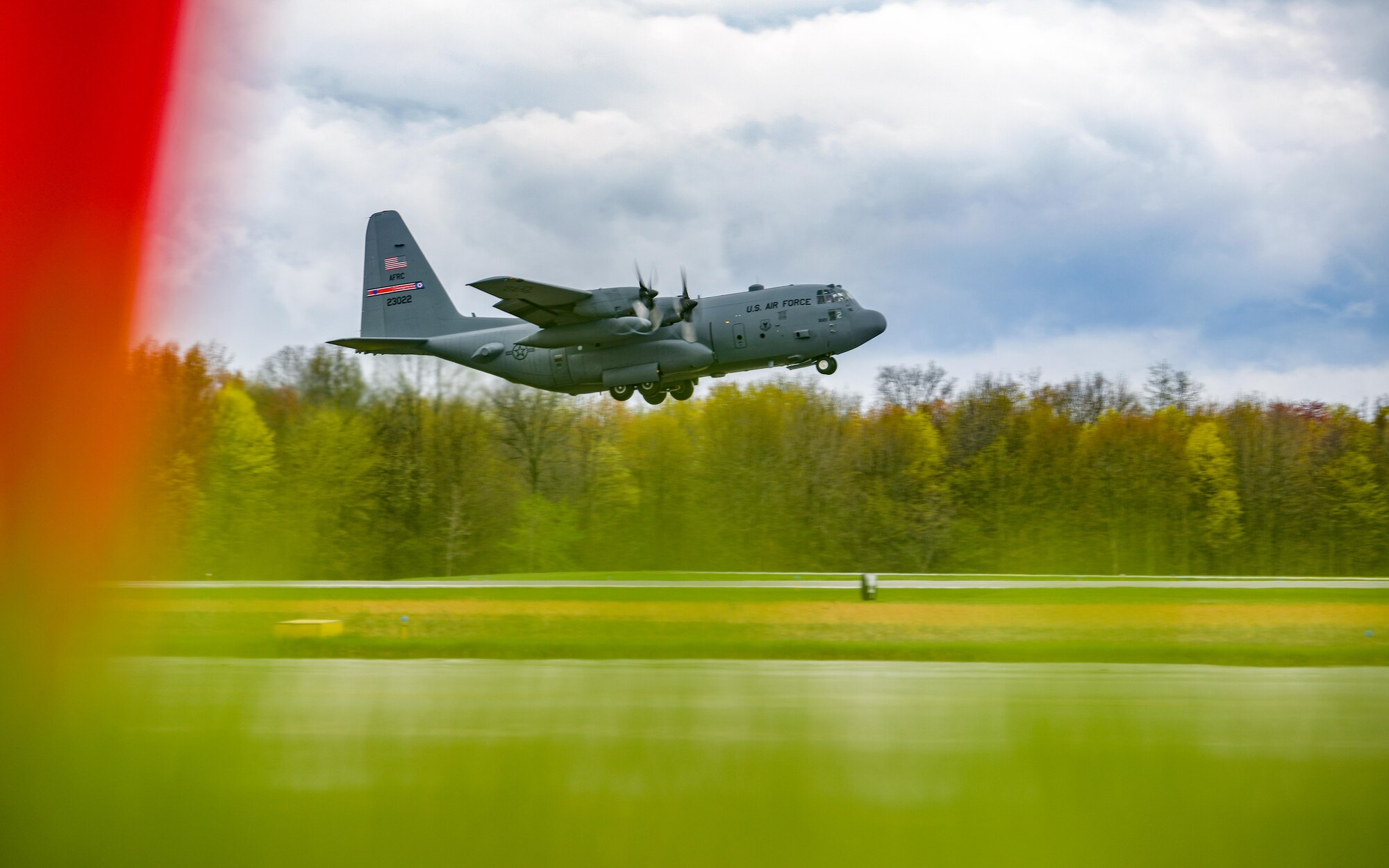 A C-130H Hercules aircraft assigned to the 910th Airlift Wing takes off from Youngstown Air Reserve Station, Ohio, on April 17, 2023, with a cargo bay full of John Marshall High School Air Force Junior Reserve Officers' Training Corps cadets.