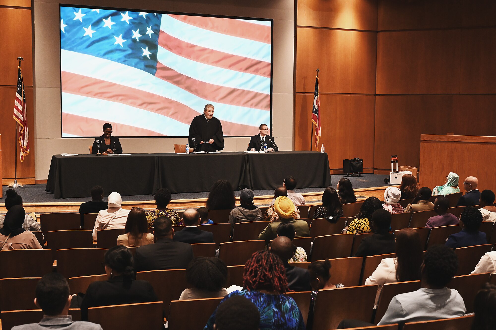 Airman Rahjay Morgan, a human resource specialist assigned to the Ohio Air National Guard's 178th Wing in Springfield, Ohio, is awarded his citizenship April 13, 2023 during a naturalization ceremony at Sinclair Community College in Dayton, Ohio. A naturalization ceremony is a formal event in which immigrants become citizens of the United States; and it typically includes the Pledge of Allegiance, the singing of the National Anthem, the reading of the Oath of Allegiance, and the presentation of certificates of citizenship. (U.S. Air National Guard photo by Shane Hughes)