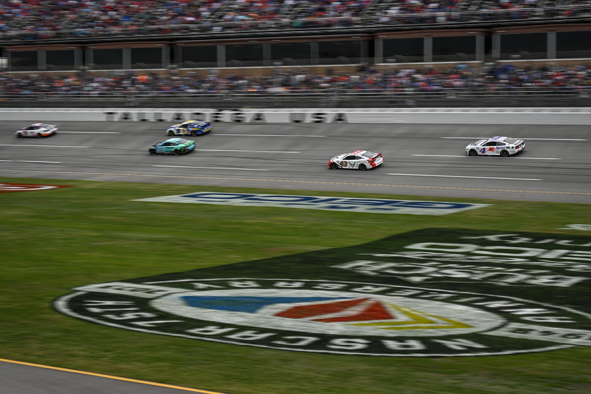 Photo of 5 cars racing.