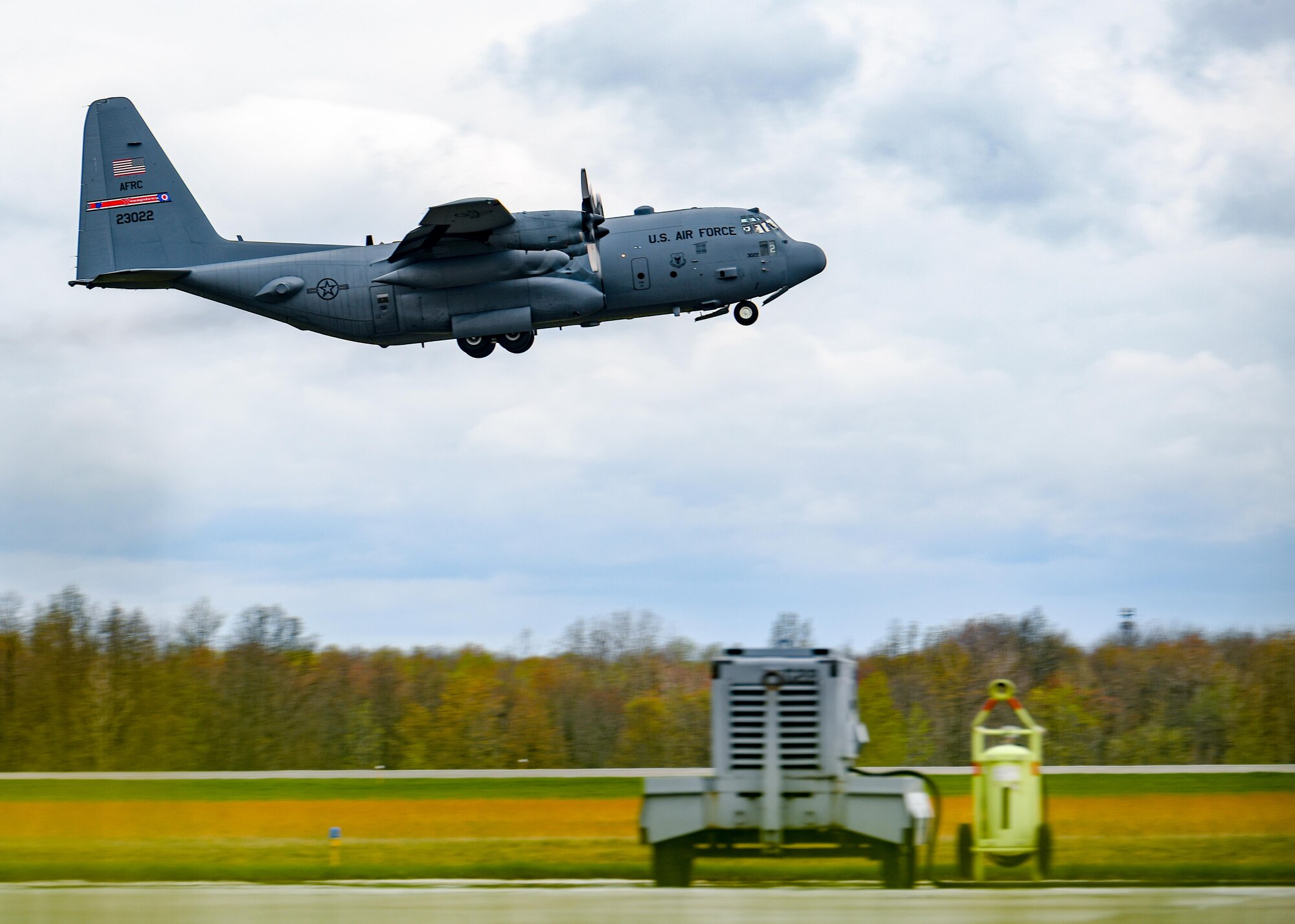 A C-130H Hercules aircraft assigned to the 910th Airlift Wing takes off from Youngstown Air Reserve Station, Ohio, on April 17, 2023, with a cargo bay full of John Marshall High School Air Force Junior Reserve Officers' Training Corps cadets.