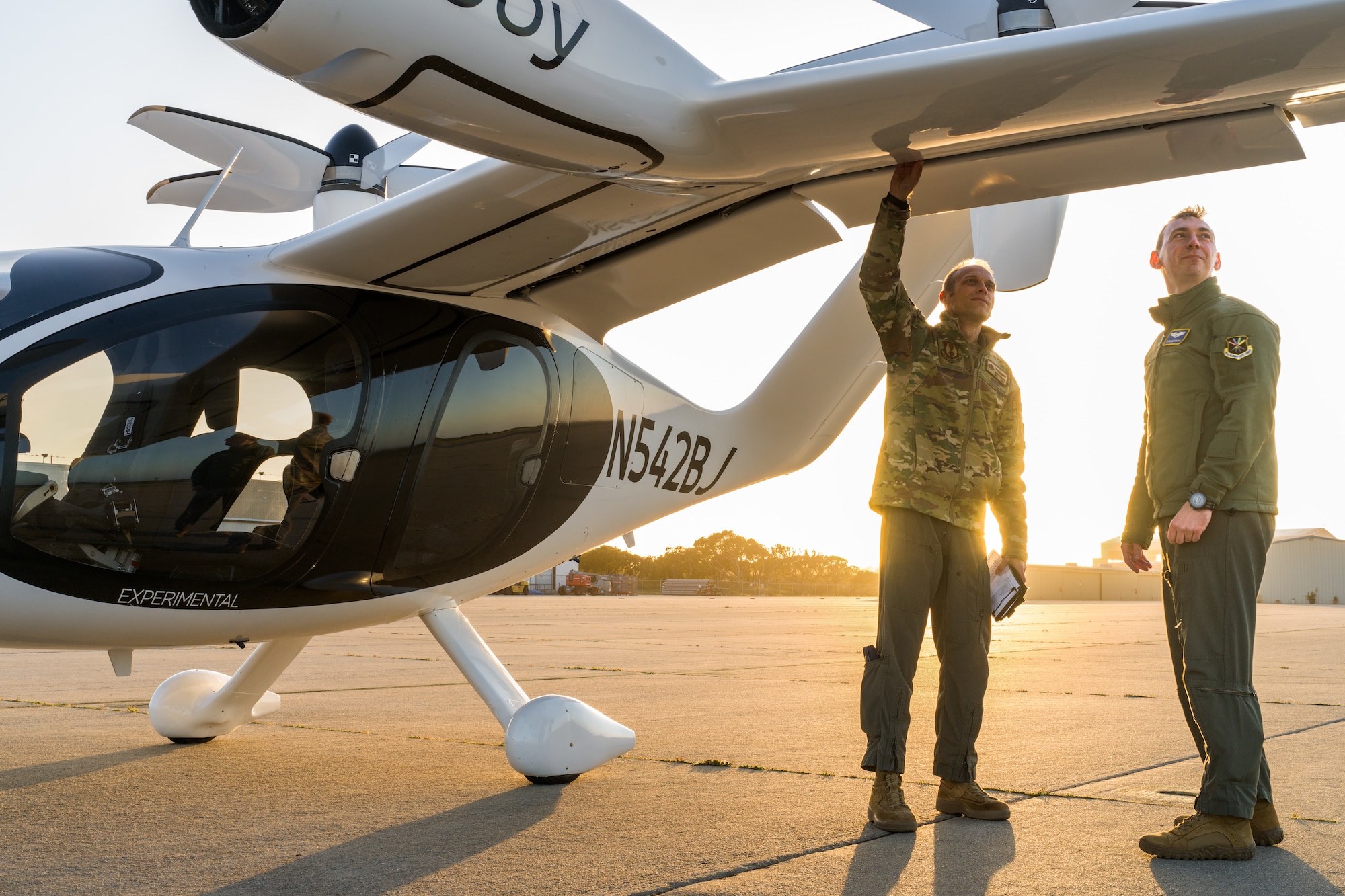 Maj. Mike Corson (left), 418th Flight Test Squadron commander, and Capt. Terrence McKenna, AFWERX Agility Prime test and experimentation lead, perform a pre-flight check on a Joby S4 aircraft. The Joby S4 is a five-seat electric vertical takeoff and landing (eVTOL) aircraft. (Courtesy photo)