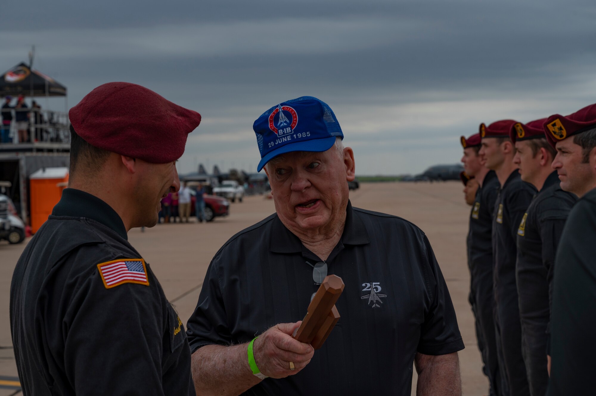 A member of the U.S. Army Golden Knights hands a ceremonial baton to retired U.S. Air Force Col. Larry Jordan during the 2023 Dyess Big Country Air Fest on Dyess Air Force Base, Texas, April 22, 2023. More than 30,000 event goers attended the one-day event highlighting the best of America’s only Lift and Strike base, Air Force heritage and Dyess community partners. The air show featured the F-22 Raptor demo team, U.S. Air Force Academy Wings of Blue, U.S. Army Golden Knights, WWII heritage flight and B-1B Lancer and C-130J Super Hercules fly overs. (U.S. Air Force photo by Senior Airman Josiah Brown)