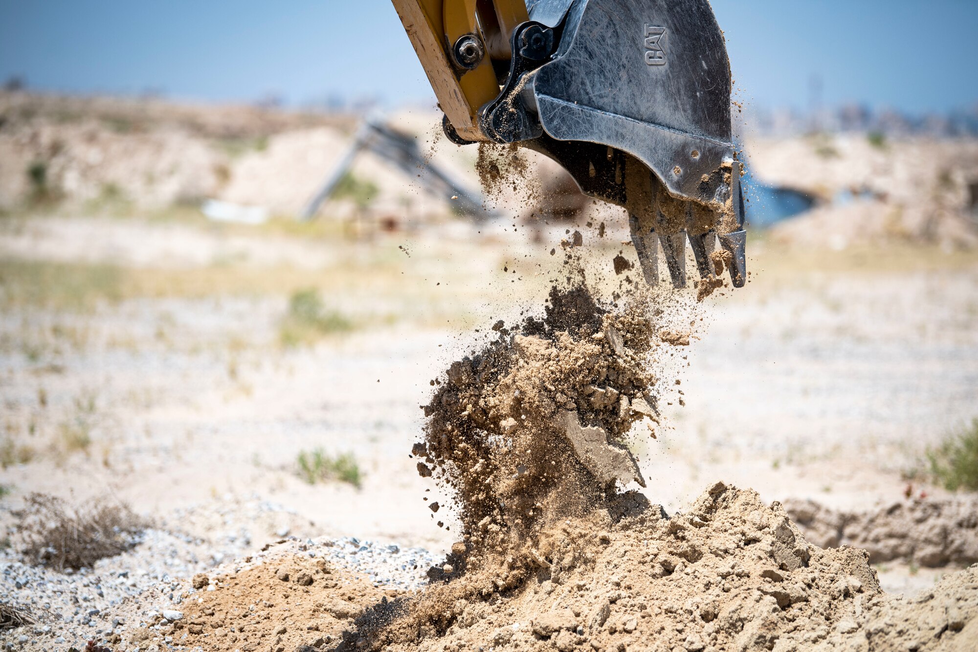 U.S. Air Force Airman 1st Class Ian Mitchell, a 386th Expeditionary Civil Engineer Squadron pavements and construction journeyman digs a trench during the installation process for a new tower at Cargo City, Kuwait, April 19, 2023.