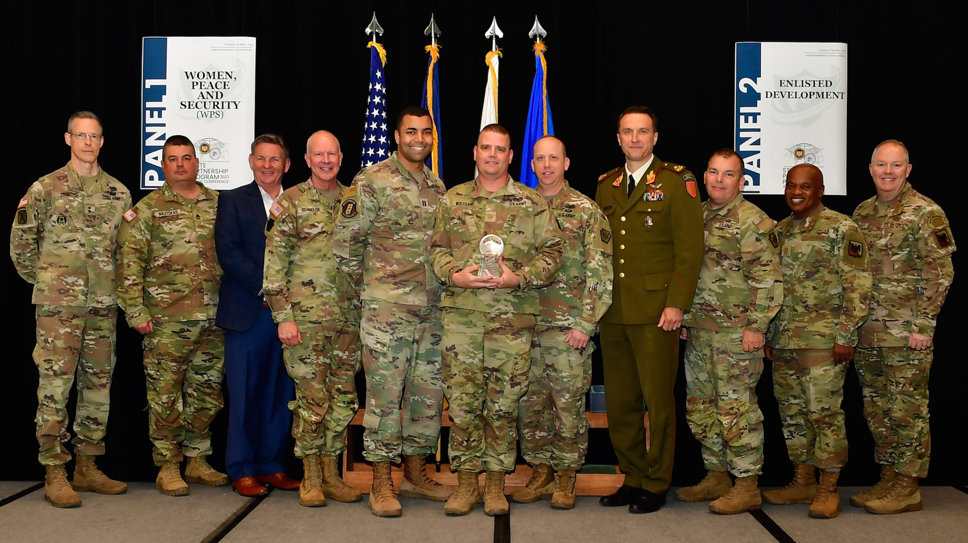Military leaders from National Guard Bureau, Pennsylvania National Guard and Lithuania pose for a photo during an award ceremony April 19, 2023, in Denver, Colorado, that named them 2022 State Partnership of the Year. The annual conference, held April 17-21, 2023, brought together all 54 SPP directors, coordinators, and senior enlisted leaders to develop innovative solutions to pressing challenges, assisting our Partner Nations. The conference culminated with an awards ceremony where a partner country of the year and a bilateral affairs officer of the year were announced. (U.S. National Guard photo by: Sgt. 1st Class Elizabeth Pena)