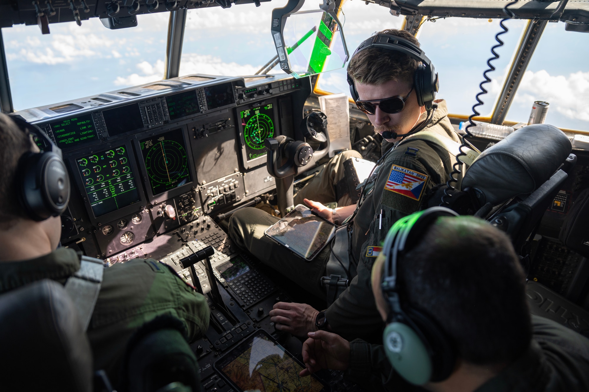 A pilot flies a C-130 over the Philippines