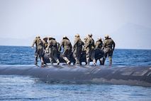 SOUDA BAY (March 27, 2022) – U.S. Marines with Task Force 61/2 (TF-61/2), aboard the Ohio-class guided-missile submarine USS Georgia (SSGN 729), prepare to launch with their combat rubber raiding craft onto the waters near Souda Bay, Greece, March 27, 2022. TF-61/2 will temporarily provide command and control support to the commander of U.S. Sixth Fleet, to synchronize Navy and Marine Corps units and capabilities already in theater, in support of regional Allies and Partners and U.S. national security interests. (U.S. Marine Corps photo by Sgt Dylan Chagnon/Released)