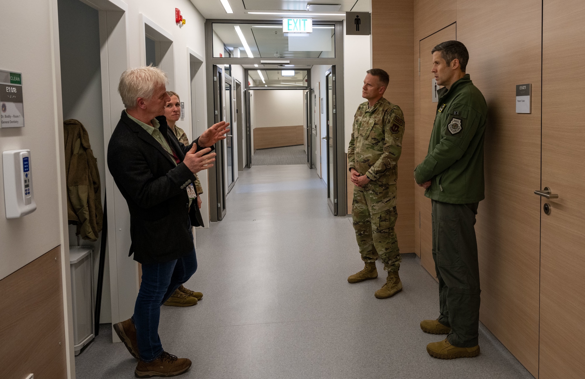 People are talking in a hallway.