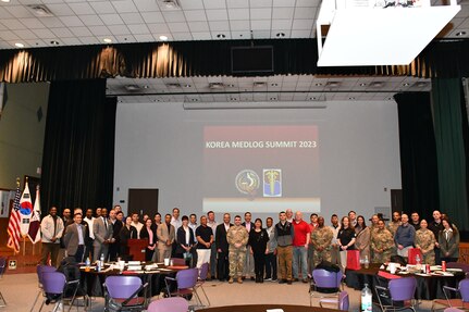 About 60 attendees of the Korea MEDLOG Summit pose for a group photo at the conclusion of the event March 20, 2023, held at the Camp Carroll Community Activity Center in Korea.