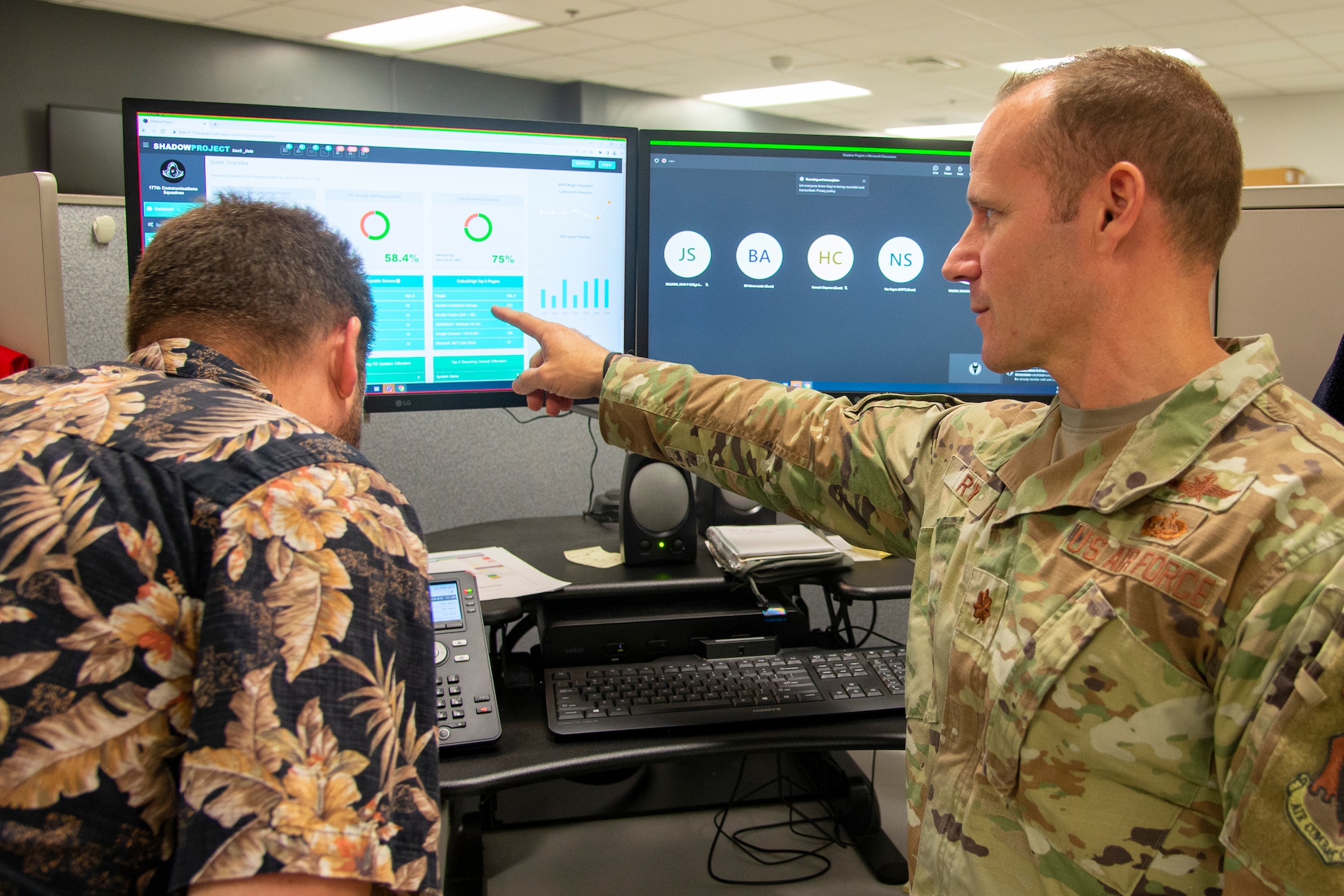 An image of  Maj. Richard Ryan, 177th Fighter Wing Communications Squadron commander, pointing to metrics on a display.