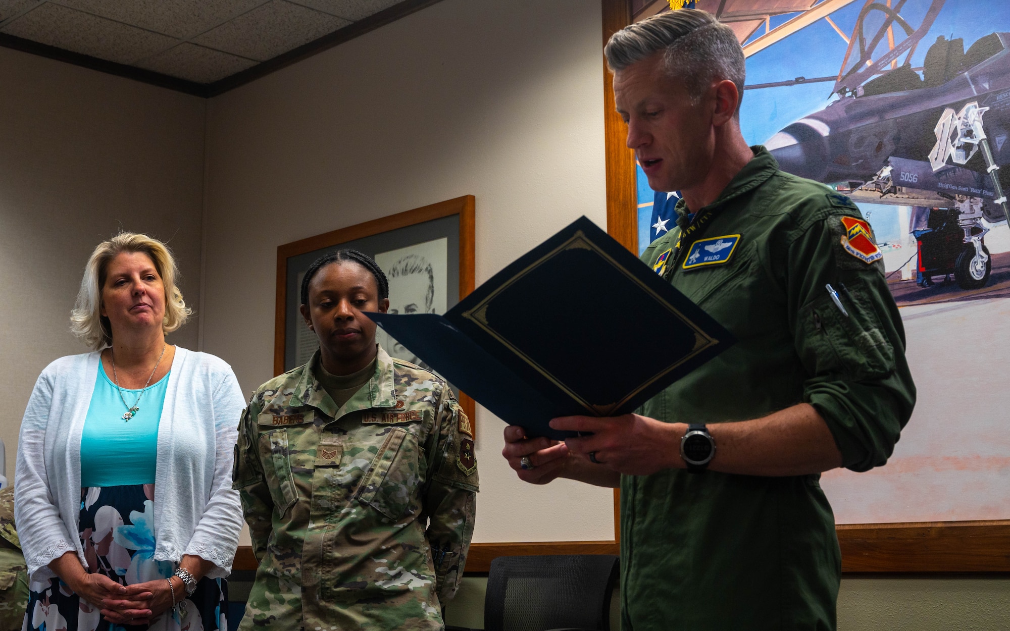 U.S. Air Force Col. Keegan McLeese, (right) 56th Fighter Wing vice commander, presents an award to Staff Sgt. Bridgette Babers (left), 56th Fighter Wing volunteer victim advocate, April 21, 2023, at Luke Air Force Base, Arizona.
