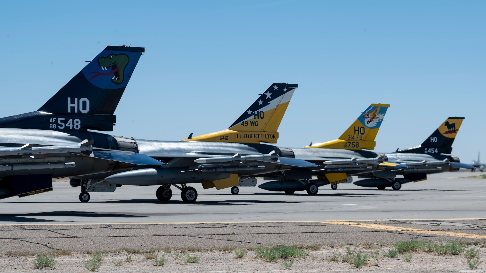The 311th Fighter Squadron, 8th FS, 314th FS and 49th Wing flagships sit on a runway during an elephant walk at Holloman Air Force Base, New Mexico, April 21, 2023.