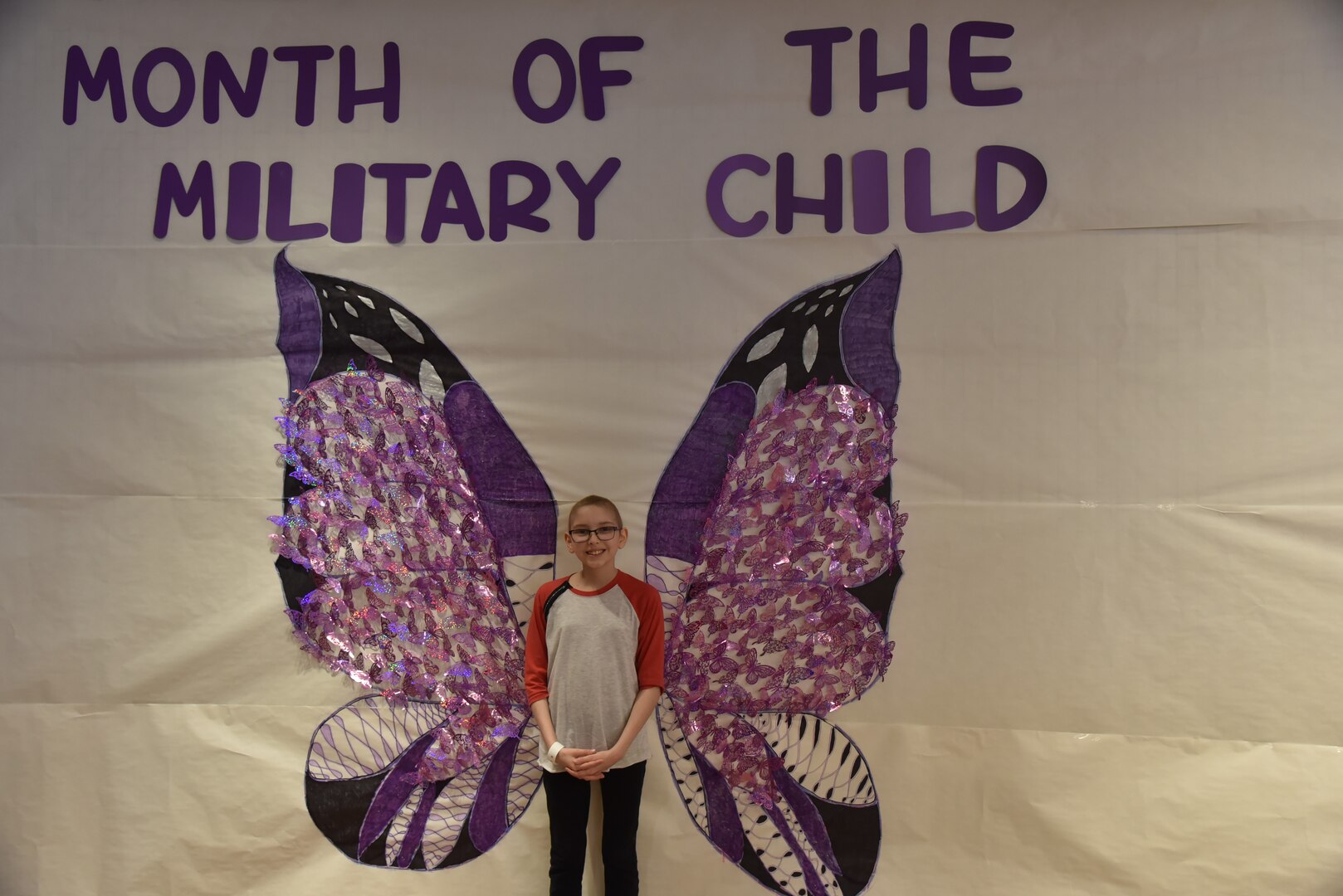 Child pose in front of sign