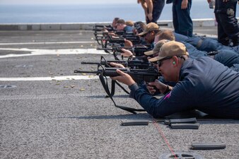 Sailors participate in a live fire shoot aboard amphibious transport dock USS Anchorage (LPD 23), April 22, 2023.