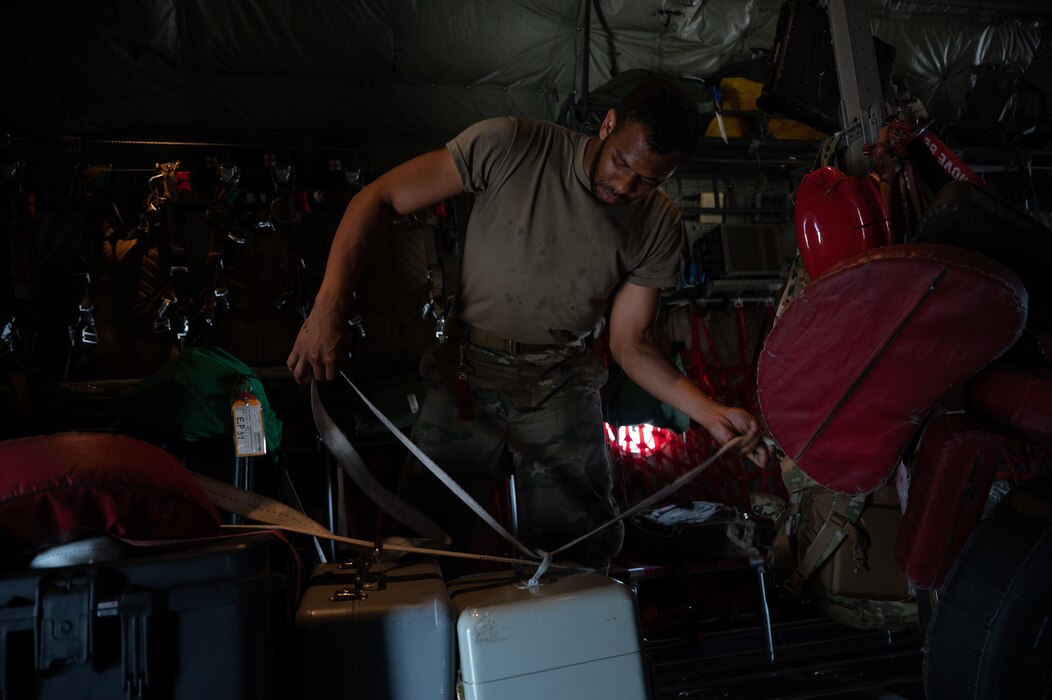 Airman loads cargo on C-130 plane