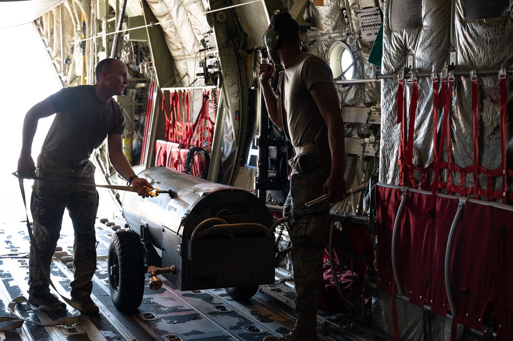Airmen loads and secure cargo preparing for mission flight