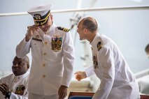 U.S. Navy Cmdr. Allen W. Jacob, right, offgoing commanding officer, Helicopter Maritime Strike Squadron (HSM) 37, welcomes Cmdr. Brian M. Mowry, oncoming commanding officer, HSM 37, to the squadron during a change of command ceremony, Marine Corps Air Station Kaneohe Bay, Marine Corps Base Hawaii, April 13, 2023. Cmdr. Allen W. Jacob relinquished command to Cmdr. Brian M. Mowry. (U.S. Marine Corps photo by Sgt. Julian Elliott-Drouin)