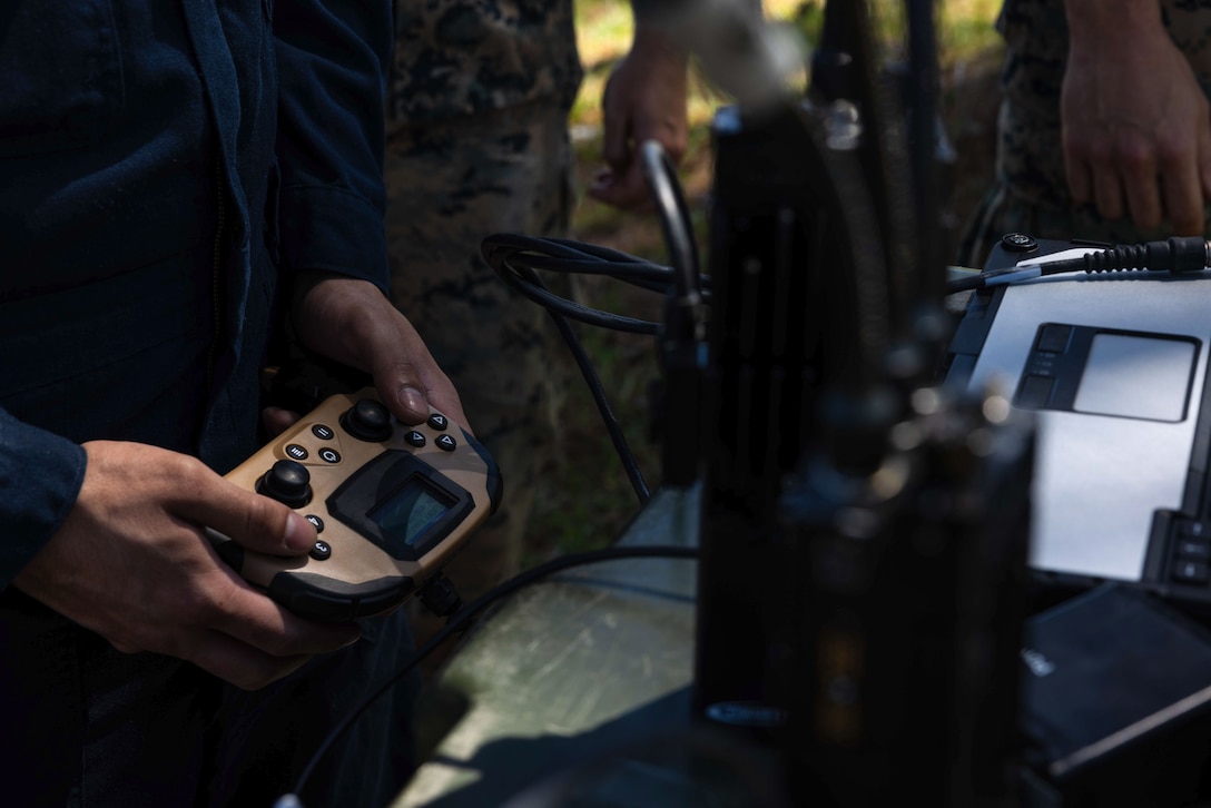 A U.S. Marine tests the controls of a Man Transportable Robot System, a robot operated by Explosive Ordnance Disposal (EOD) technicians to remotely diffuse explosives, during an EOD open house event at MCAS Cherry Point, North Carolina, April 12, 2023. EOD hosted this event to inform Marines about the mission of EOD, provide demonstrations of the equipment utilized to accomplish their mission, and to provide a steppingstone for those interested in transiting into the EOD military occupational specialty. (U.S. Marine Corps Cpl. Jade Farrington)