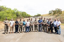 Hawaii state elected officials and staff members pose for a group photo with Marine Corps Base Hawaii leadership during a tour of Puuloa Range Training Facility, Hawaii, April 17, 2023. The engagement provided MCBH leadership and elected officials an opportunity to discuss the range’s training operations, recent facility changes, environmental stewardship efforts, and future initiatives to mitigate training noise impacts to the neighboring community. (U.S. Marine Corps photo by Cpl. Brandon Aultman)