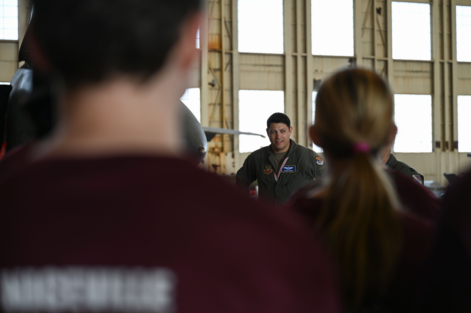 U.S. Air Force Major Seth J. Brown, 350th Spectrum Warfare Wing chief of current operations, briefs students from Niceville High School FL-33AF JROTC at Eglin Air Force Base, Fla., April 21, 2023. During the tour students learned about how the 350th Spectrum Warfare Wing delivers adaptive and cutting-edge electromagnetic spectrum capabilities that provide the warfighter a tactical and strategic competitive advantage and freedom to attack, maneuver, and defend. (U.S. Air Force photo by Staff Sgt. Ericka A. Woolever)