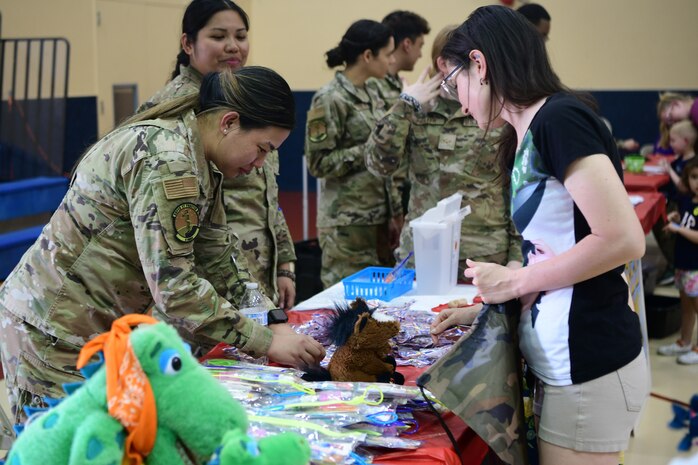 An Airman stamps a checklist during the Day for Kids event at the Youth Center on Beale Air Force Base, California, April 21, 2023.