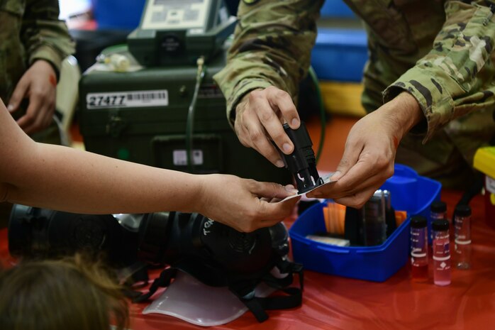 An Airman stamps a checklist for the Day for Kids event at the Youth Center on Beale Air Force Base, California, April 21, 2023.