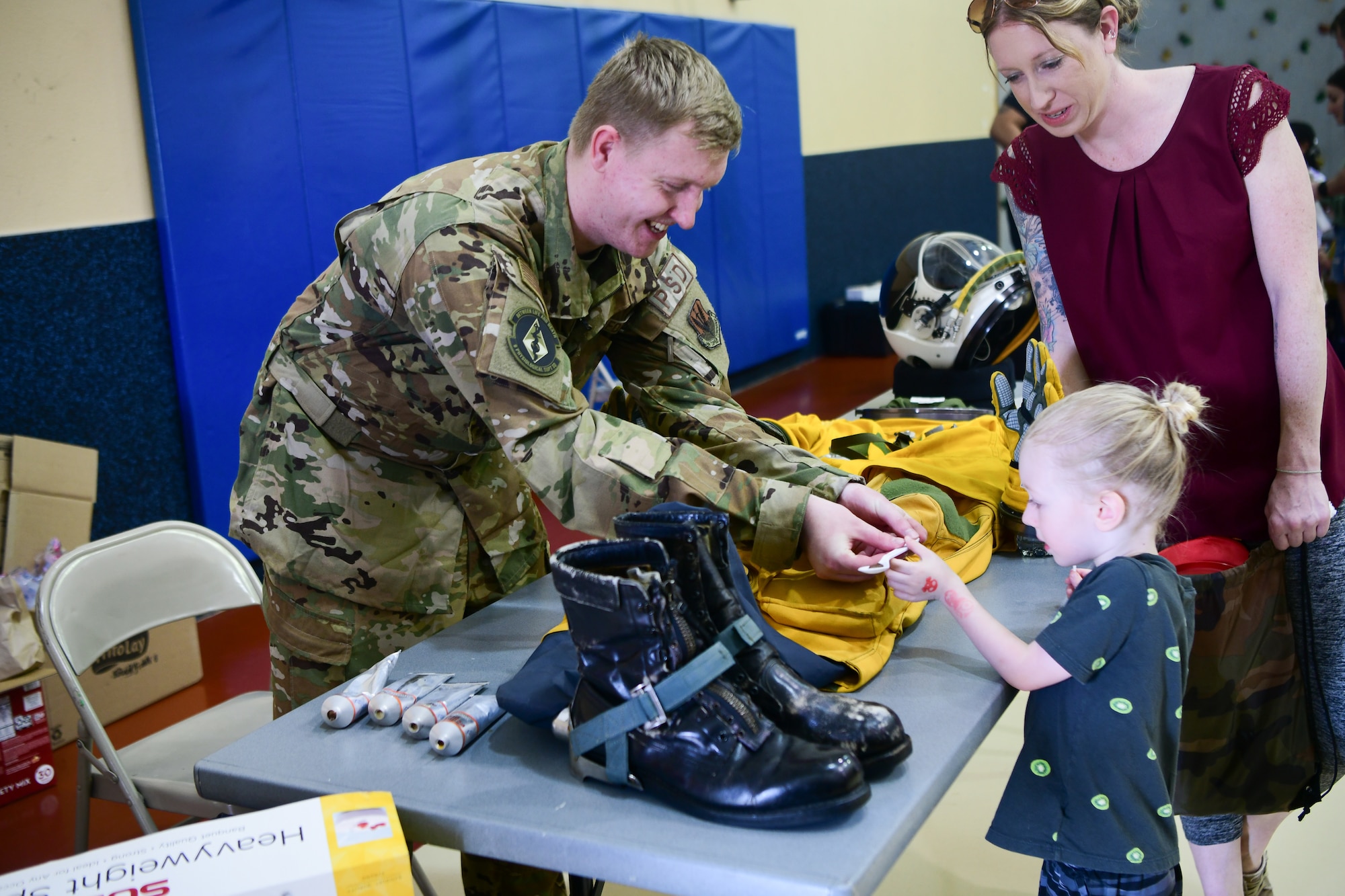 U.S. Air Force Airman 1st Class Adam Dzekunskas, 9th Physiological Support Squadron technician, hands out samples of tube food during the Day for Kids event at the Youth Center on Beale Air Force Base, California, April 21, 2023
