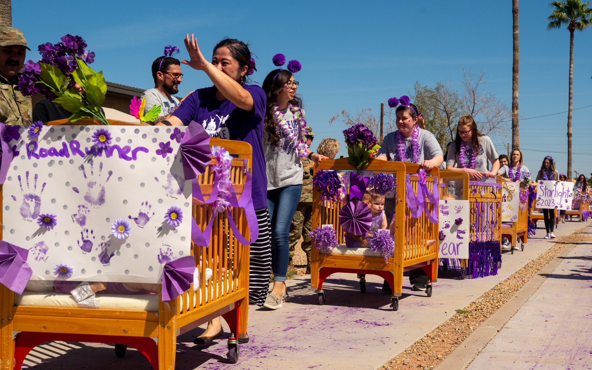 Children and caretakers from the Luke Air Force Base Child Development Center participate in a Purple Up parade, April 21, 2023, at Luke AFB, Arizona.