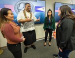 Asian American Pacific Islander Employee Resource Group co-leads Viliamu Kuaea, middle left, and Tiera Beauchamp, middle right, visit with participants April 18, 2023, during a celebration of American Samoa Flag Day at Puget Sound Naval Shipyard & Intermediate Maintenance Facility, in Bremerton, Washington. (U.S. Navy photo by Wendy Hallmark)