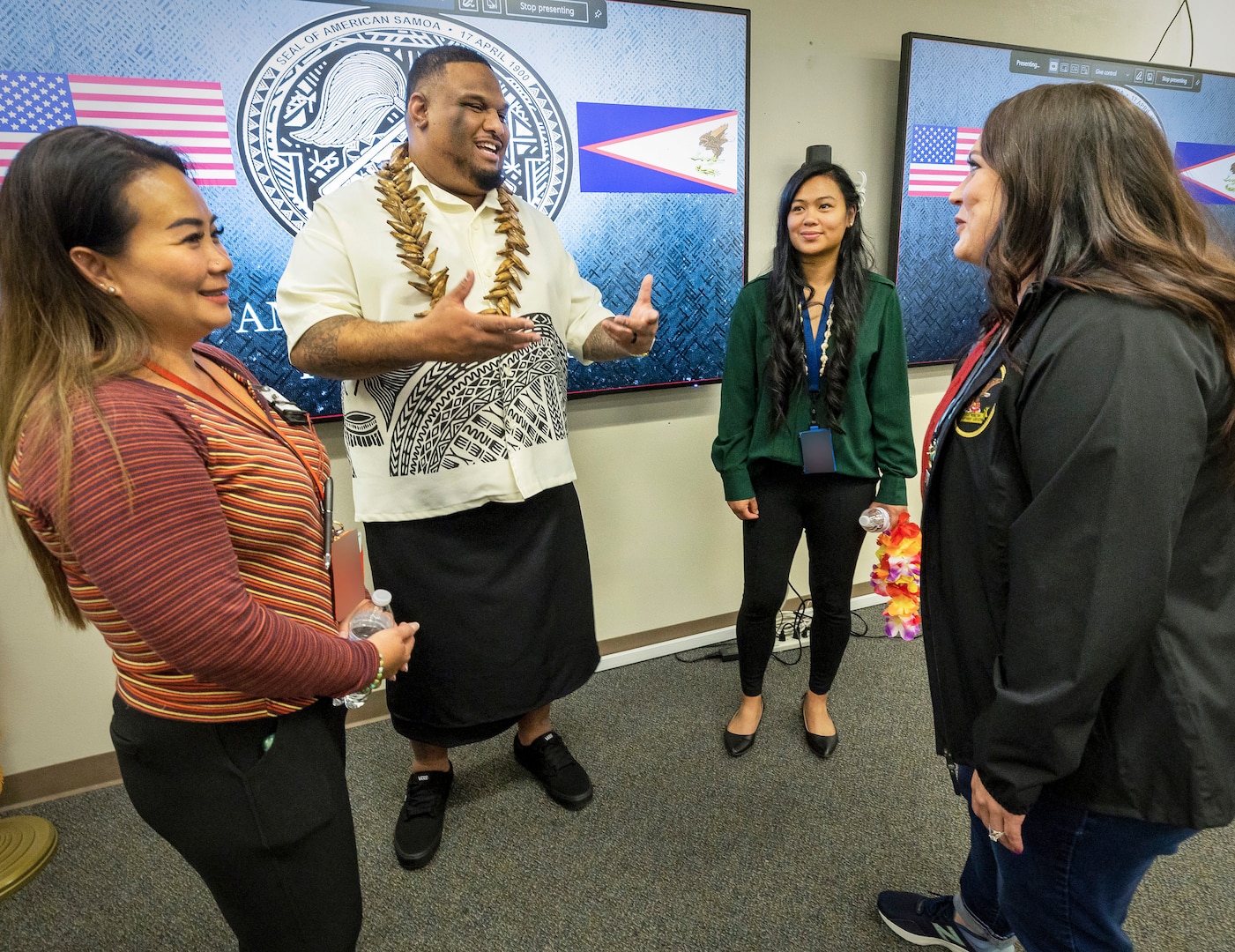 Asian American Pacific Islander Employee Resource Group co-leads Viliamu Kuaea, middle left, and Tiera Beauchamp, middle right, visit with participants April 18, 2023, during a celebration of American Samoa Flag Day at Puget Sound Naval Shipyard & Intermediate Maintenance Facility, in Bremerton, Washington. (U.S. Navy photo by Wendy Hallmark)