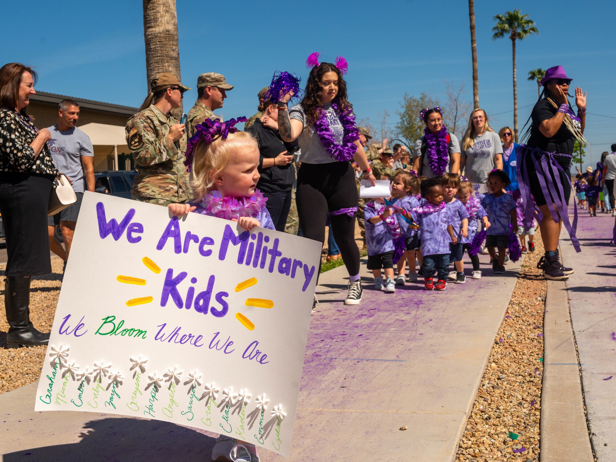 Children and caretakers from the Luke Air Force Base Child Development Center participate in a parade, April 21, 2023, at Luke AFB, Arizona.