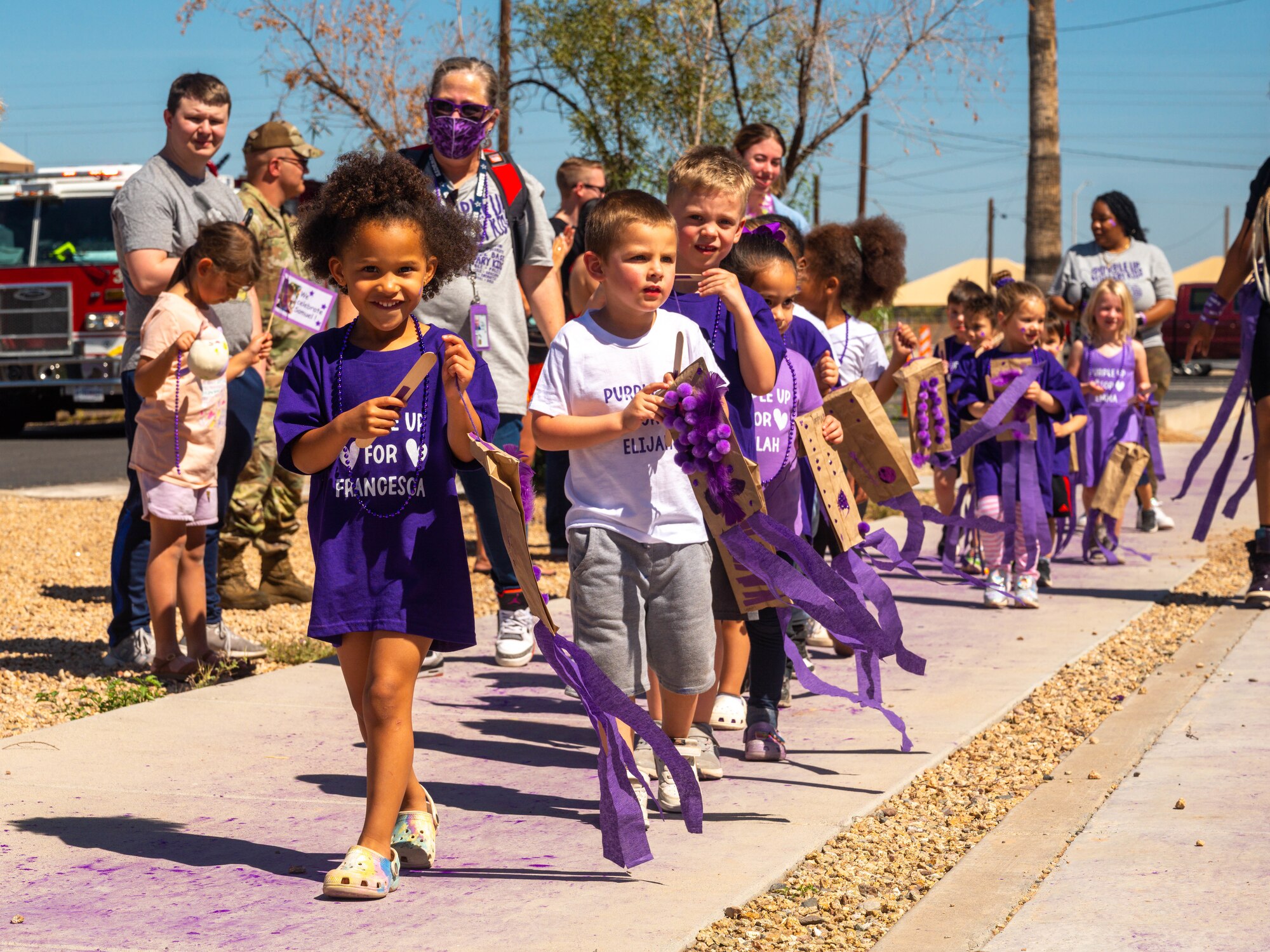 Children and caretakers from the Luke Air Force Base Child Development Center participate in a parade, April 21, 2023, at Luke AFB, Arizona.