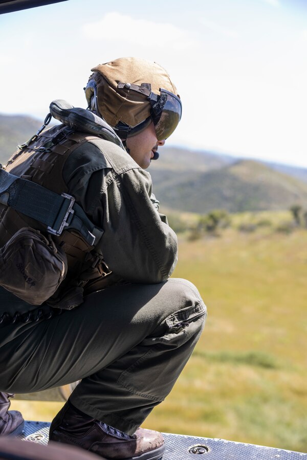 U.S. Marine Corps Cpl. Shokhrukh Saidjanov, a UH-1Y Venom crew chief with Marine Light Attack Helicopter Squadron 367, Marine Aircraft Group 39, 3rd Marine Aircraft Wing, surveys the area during the Cory Iverson Wildland Firefighting exercise at Marine Corps Base Camp Pendleton, California